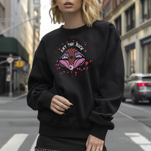 a black sweatshirt featuring a psychedelic "Eat the Rich" design with an eyeball and vampire teeth,